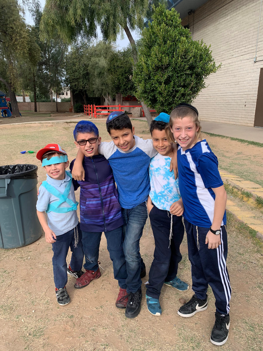 A group of PHA boys smiling together outside